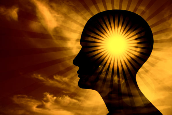 The silhouette of a head with a sunburst inside. 